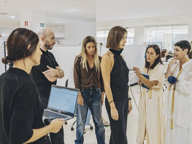 Employees at the multinational clothing company Inditex, during a fitting session with a model.