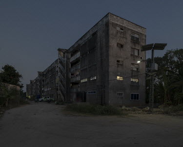 A brutalist residential block, built by the GDR, in an area where, according to local beliefs, night time attacks by a nocturnal shape-shifting bat-like entity locally called 'Popobawa' ( 'bat wing' i...
