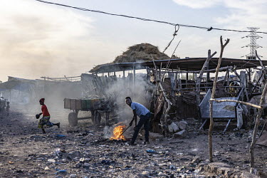 A man tends to a fire in the Faladie camp for displaced persons where 3,600 people are crammed together after fleeing attacks in the centre of the country. 80% of the refugees are Fulani.