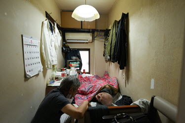 Dr. Osamu Yamanaka (68) visits Minoru Tanaka (85) to check his health. Tanaka lives in a single occupancy room in Kotobuki, a town made famous during Japan's economic boom as the 'city of day labourer...