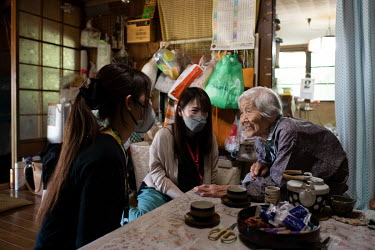 Toshie Ueno (92), the last resident of a hamlet in a mountainous area in Shikoku, talks to a staff member from the regional revitalisation promotion division and a hamlet supporter from city hall in h...