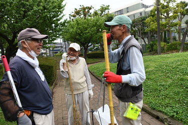 Chikao Hayashi (86), Tadashi Sakurai (75) and Toru Fukuda, members of Setagaya Ward's Silver Human Resource Centre (SHRC), stop for a chat during the three hours there are cleaning a park together. Th...