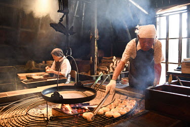 Chikayoshi Gonda (98) cooking dumplings in a large iron pan at the 'Ogawa no sho' restaurant where he works a few days a week. Chikayoshi has been working at the company since it was founded in 1986....