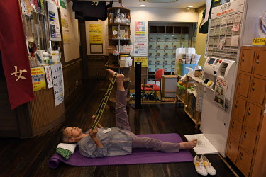 Nanae Takaishi (100) exercises in the dressing room of the 'Shinseiyu' bathhouse. Nanae started rock climbing and mountaineering when she was 70 years old as a hobby and kept climbing until she was 92...