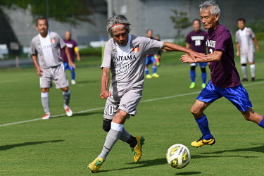 A senior football team, consisting of members over 70 years old, practices before a regional football match for the over 70s. In each prefecture in Japan, there are over 70s teams that belong to the J...