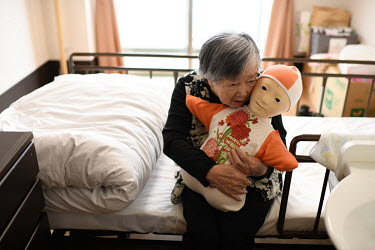 Kazuko Kori (89) hugs and talks to Telenoid, a remotely-operated android robot, at the Yume Paratiis nursing home. The Telenoid robot has been found to be of help for people suffering from dementia. I...