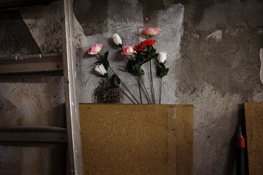 Plastic flowers in a basement.