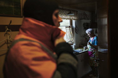 Farmer Paetur with his grandmother (85) in the kitchen of their home where they have lived since he was a child. The farm is the main constituent of the village of Kaldbaksbotnur. His 85-year-old gran...
