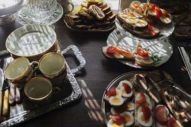 Coffee, biscuits and sandwiches served on porcelain tableware at a memorial service ( wake ) following a funeral.