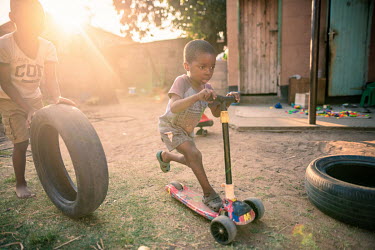 Four year old Leon Mhike, who was born with bilateral clubfoot, plays with scooter outside his home. After receiving treatment via the Ponseti method, Leon now enjoys full mobility and is able to take...
