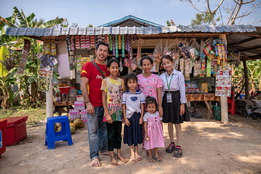 Three-year-old Maramy, who was born with clubfoot, poses for a picture with her family in front of their grocery store outside Battambang.Clubfoot, a condition that causes one or both feet to be twist...