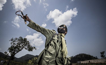 An unarmed Park Ranger practices with a slingshot in the Western Area National Park.In Sierra Leone, businesses are taking advantage of poor legislation, feeble enforcement and high levels of corrupti...