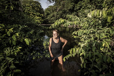 Jane Aspden, a resident of Black Johnson Beach, south of Freetown. The beach is being developed as a port for Chinese fishing boats and mangrove swamps like the one she is standing in are coming under...