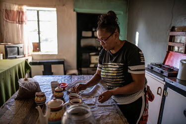 Anisha Salomo, a Khoisan rooibos farmer whose family has been harvesting the plant for generations, brews a batch of rooibos tea at her grandparents' home.