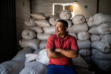 Collin Swartz, who overseas quality control at the Wupperthal Original Rooibos Co-operative, in the coop's warehouse where sacks of rooibos await forwarding for secondary processing.