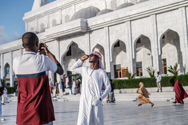 Young people socialise and take photographs in the compound of the Ali Jimale Mosque, inaugurated in July 2022 in a wealthy area of the city.