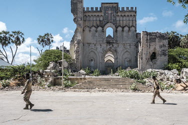 Soldiers walk in front of the the ruins of the Italian-built Mogadishu cathedral.
