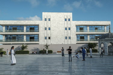 Young people socialise and take photographs in the compound of the Ali Jimale Mosque, inaugurated in July 2022 in a wealthy area of the city.