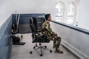 A soldier on guard in the compound of the mayor's office.