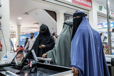 Women queue at a checkout while shopping at the Hayat Market supermarket, on one of the newest commercial streets in the Wadajir district.