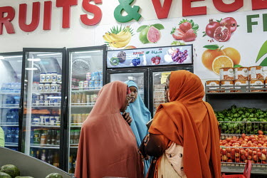 Women stop to socialise while shopping at the Hayat Market supermarket, on one of the newest commercial streets in the Wadajir district.