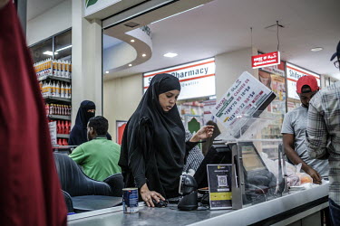 A woman working at a checkout at the Hayat Market supermarket, on one of the newest commercial streets in the Wadajir district.