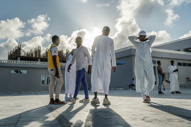 Young people socialise in the compound of the Ali Jimale Mosque, inaugurated in July 2022 in a wealthy area of the city.