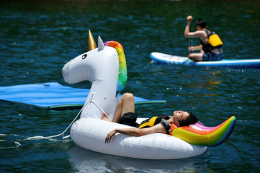 A tourist relaxes on a novelty inflatable while enjoying a boat excursion in the waters off of Turtle Island.