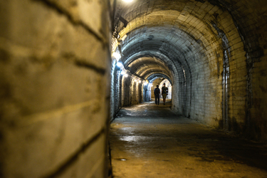 Visitors walk through a former military tunnel complex running through the strategically-important Turtle Island.