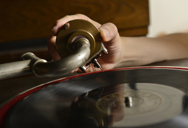 Record collector Dr Hsu Deng-fang carefully places the stylus of an antique gramophone onto a record as he sits amidst his collection of gramophones, records and associated memorabilia located above h...