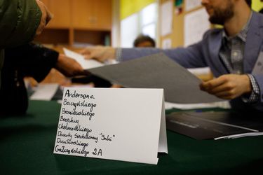 Local street names identify where people should sign in at a polling station, in a primary school, before voting in the 15 October 2023 parliamentary elections.