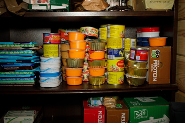 Tins of food stacked in a storage room at the home, near the Belarus border, of family of activists who help illegal migrants crossing the frontier.