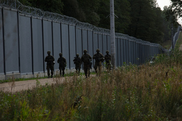 Soldiers on patrol the fence that marks the border with Belarus.