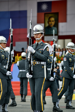 Honour Guards perform drills in front of a huge portrait of Dr. Sun Yat-sen, the founding father of the Republic of China (Taiwan) on Taiwan's 112th National Day.