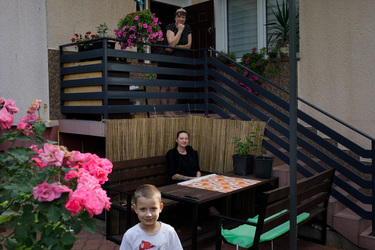 Dominika Wnukowski (centre) with her son Stas and her mother outside their house which is in a village near the border with Belarus.
