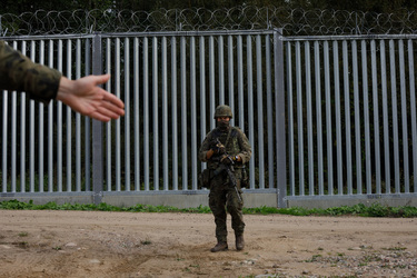Soldiers on patrol the fence that marks the border with Belarus.