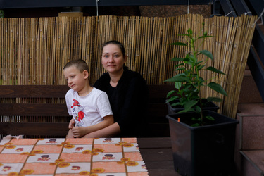 Dominika Wnukowski with her son Stas outside their house which is in a village near the border with Belarus.