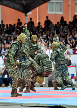 Members of an anti-terrorism squad demonstrate their hand-to-hand combat skills in front of an audience of dignitaries and members of the public on Taiwan's 112th National Day.