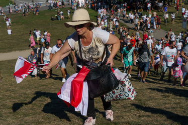 A woman with Polish flags walks among a large crowd who have came to watch the largest military parade ever held in post-communist Poland. The event involved 2,000 soldiers and 200 pieces of military...