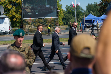 Bodyguards escort Antoni Macierewicz, Vice President of the Law and Justice party, as they walk past a large crowd who have came to watch the largest military parade ever held in post-communist Poland...