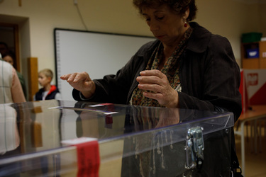 A woman places his voting forms into a ballot box after casting his vote at a polling station in a primary school for the 15 October 2023 parliamentary elections. The voter turnout is expected to be a...