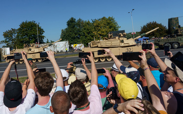 People take pictures as an American Abrams tanks roll past a large crowd who have came to watch the largest military parade ever held in post-communist Poland. The event involved 2,000 soldiers and 20...