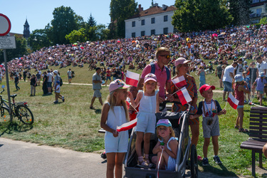 A family holding Polish flags among a large crowd who have came to watch the largest military parade ever held in post-communist Poland. The event involved 2,000 soldiers and 200 pieces of military eq...