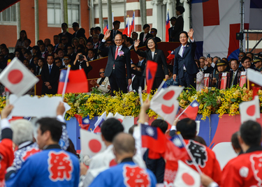 President Tsai Ing-wen (centre, waving) attends Taiwan's 112th National Day ceremony along with other high-ranking DPP party, forign diplomatic representatives, ROC military officials and, among the c...
