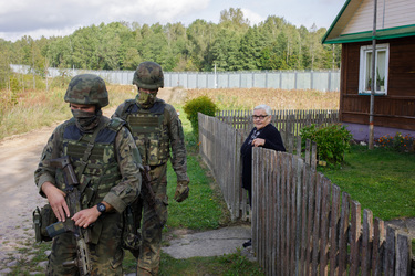 Ms Renia, who lives in a house just by the border wall with Belarus, is visited by Polish soldiers who patrol the border.