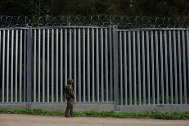 Soldiers on patrol the fence that marks the border with Belarus.
